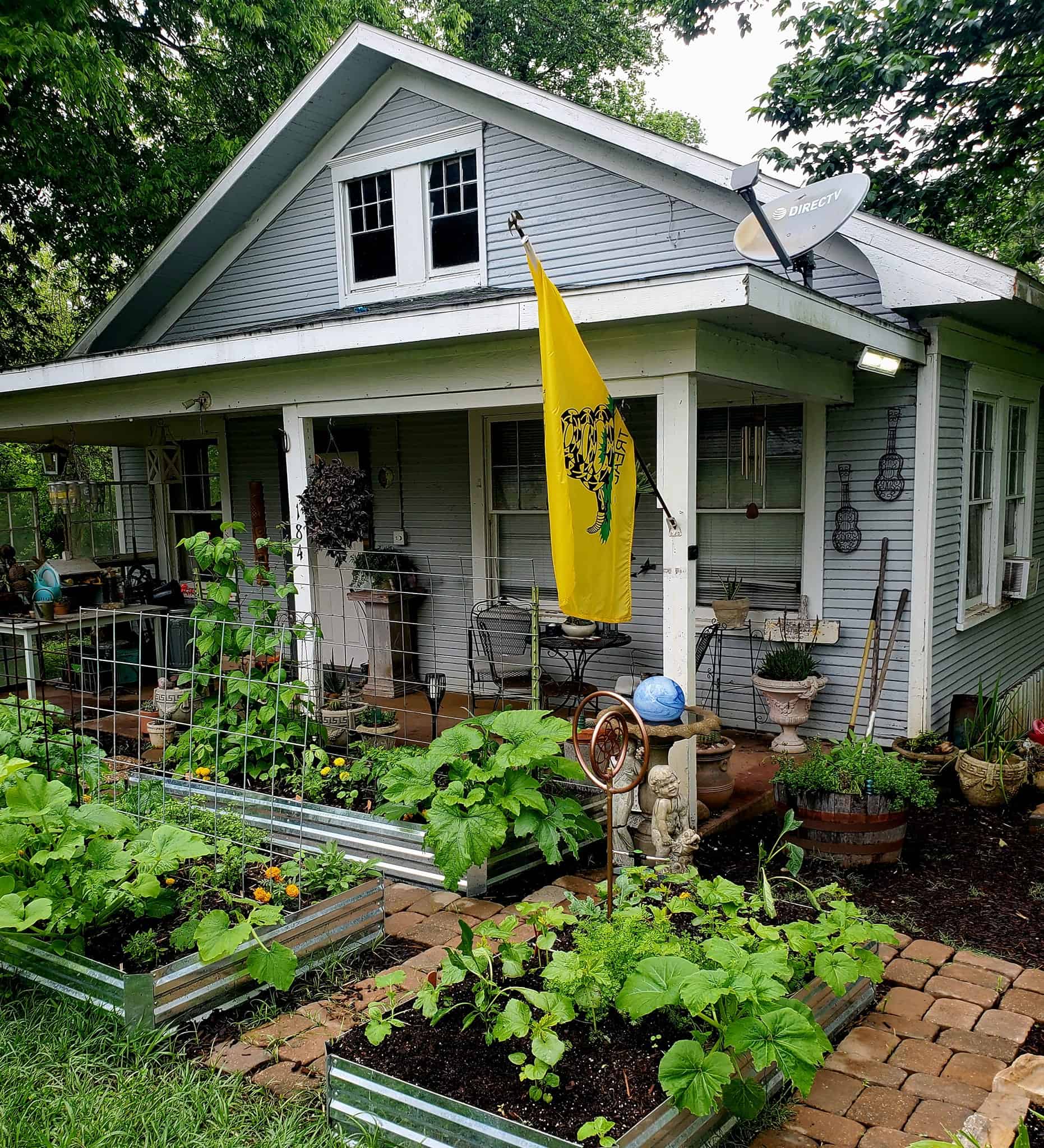 a home with a raised beds garden in front