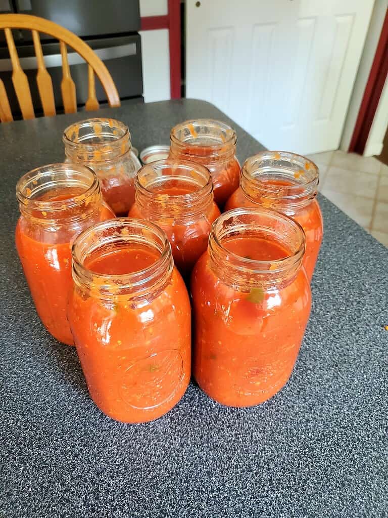 few jars of tomato sauce ready to be canned
