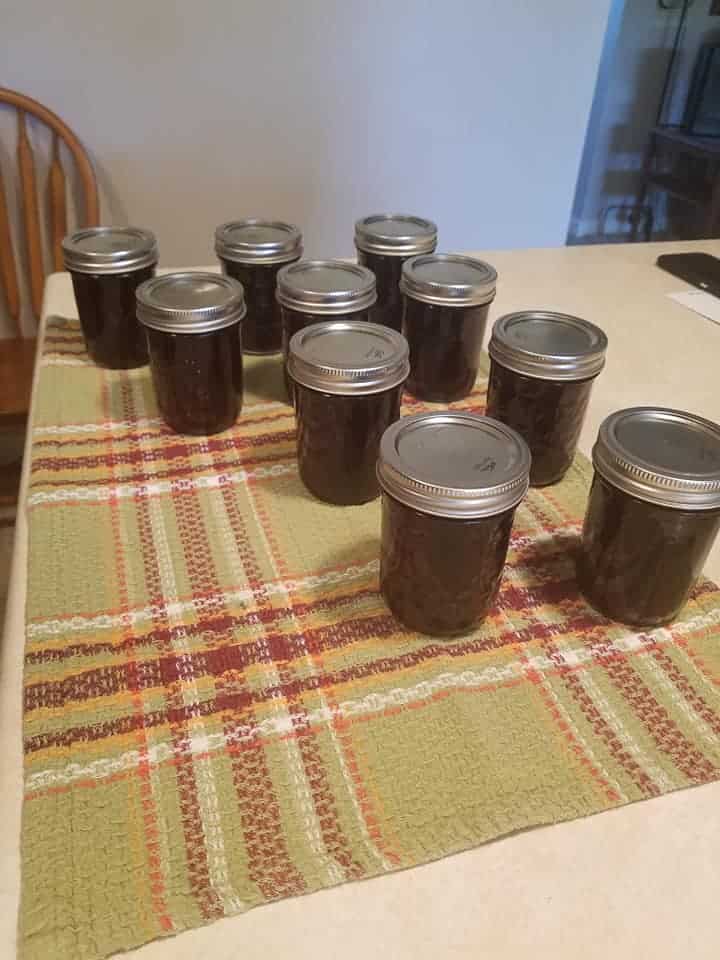 10 jars of blackberry jam in a table