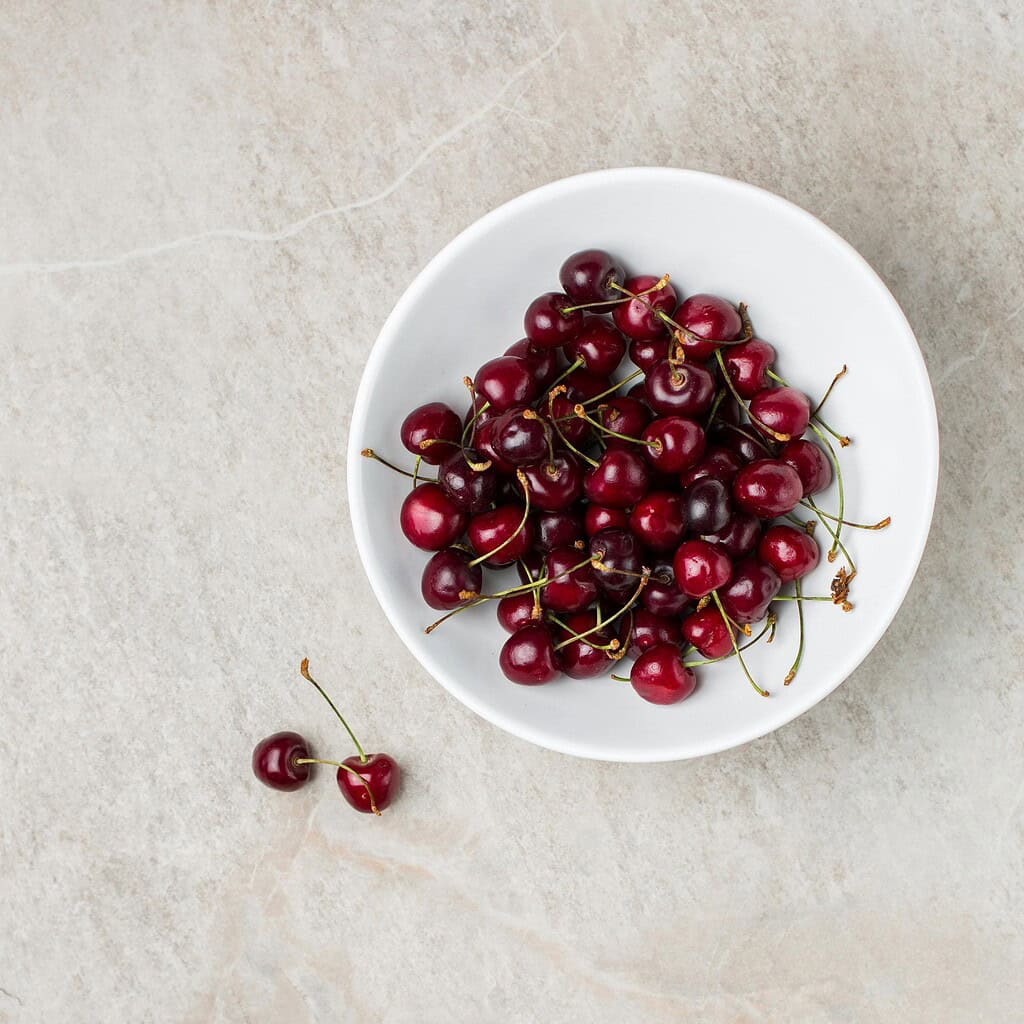 cherries in a white bowl