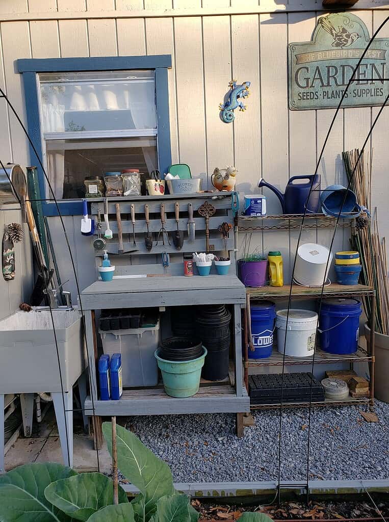 garden tools stored in a garden bench made of pallet