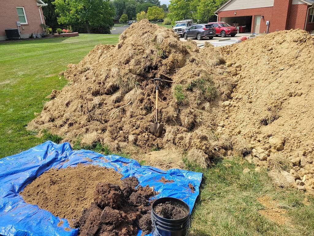 a compile of soil, manure, and compost in a backyard