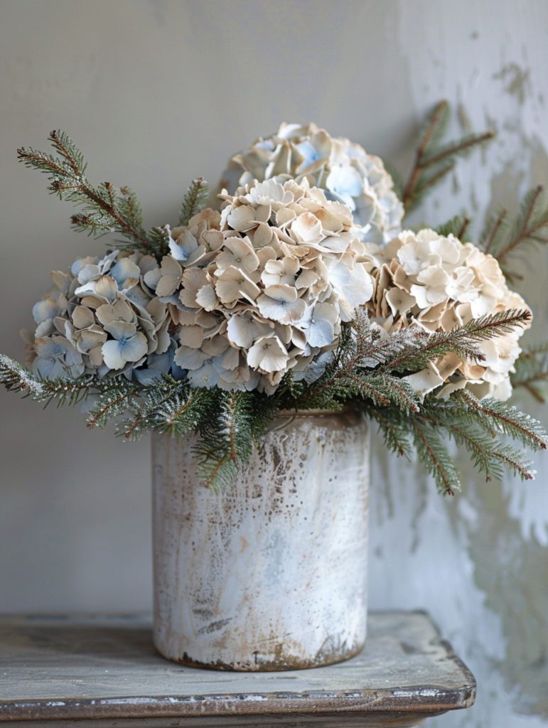 Winter planter in a cement or metal container, filled with dried hydrangea heads in soft blue, dusty pink