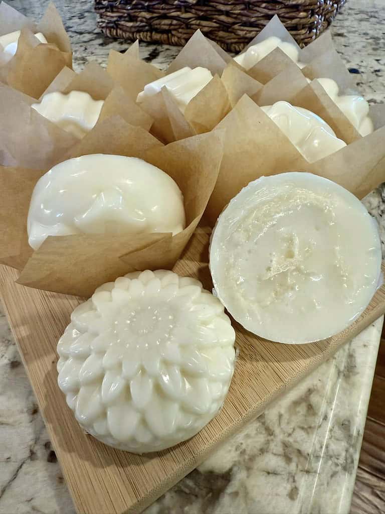 beautifully crafted handmade soaps displayed on a light wooden cutting board atop a granite countertop