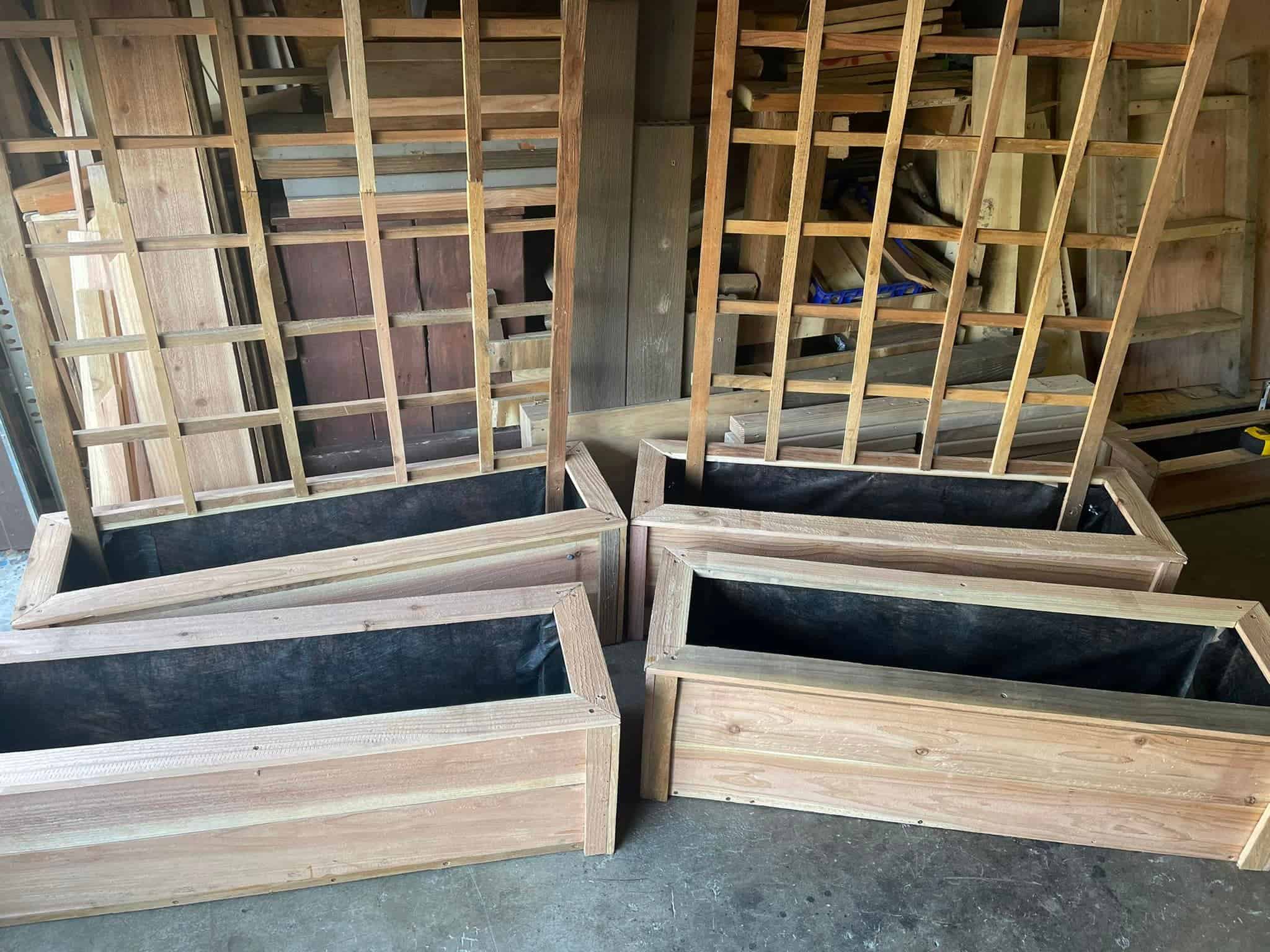 handcrafted wooden planter boxes arranged inside a rustic woodworking shed