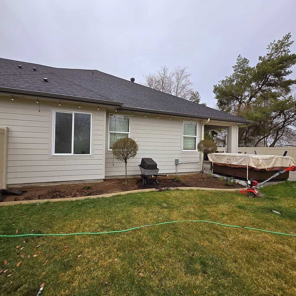 a suburban backyard in early spring or late winter, just beginning its seasonal garden transformation.
