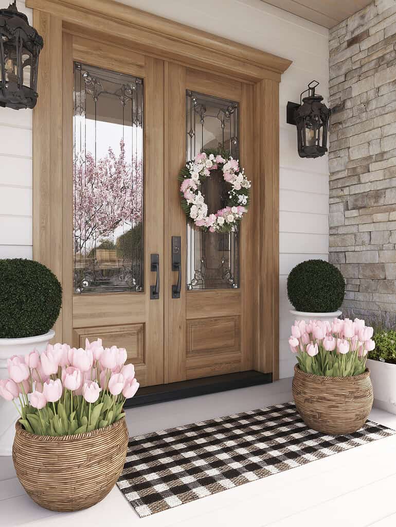 a warm and welcoming modern farmhouse-style front porch, showcasing a natural wood double front door with decorative glass panels and side lights. 