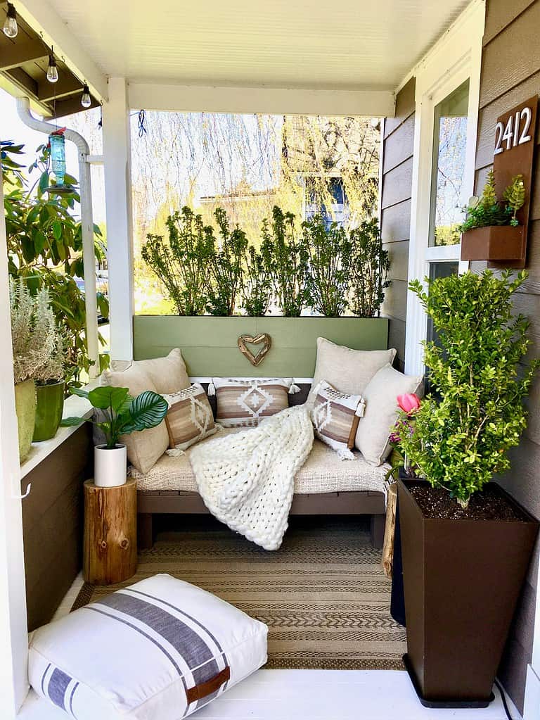 a cozy, beautifully styled small front porch nook