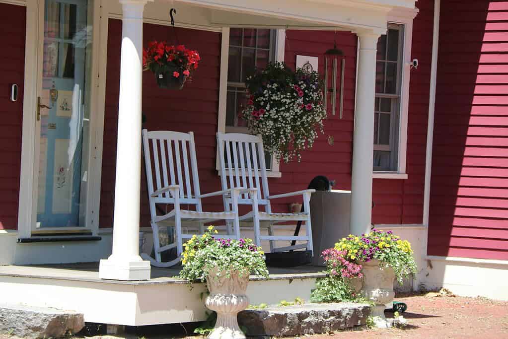 a charming country farmhouse front porch in bright summer daylight.